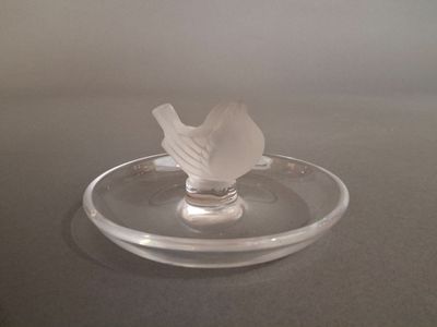 a glass plate with a napkin in it on a table