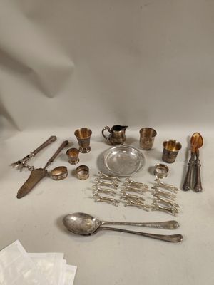 a lot of silver items on a table with a white background