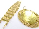 two pieces of jewelry that include a gold coin and a chain