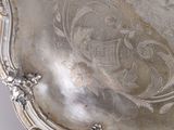 a silver tray with a design on it on a table