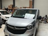 a silver van parked in a garage next to other cars
