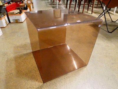 a brown table with a glass top in a store