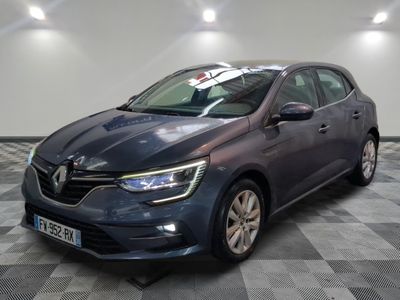 a grey car parked in a garage with a checkered floor