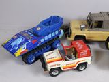 several toy vehicles are lined up on a white surface