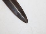 a large knife that is laying on a table