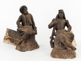 paire de figurines en bois sculpté représentant un homme et une femme assis sur un rocher