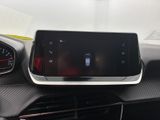 the dashboard of a car with a cell phone in the center of it