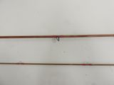 two fishing rods hanging on a wall in a room