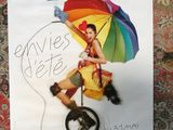 a poster of a woman with an umbrella on a wall