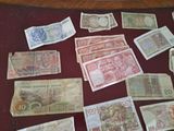 many different types of foreign currency on the table