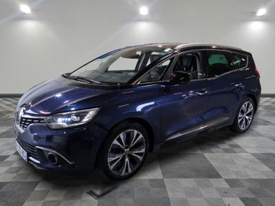 a blue car parked in a garage with a checkered floor
