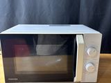 a microwave that is sitting on a wooden table