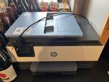 a printer sitting on top of a counter next to a bottle of wine