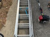 a ladder that is sitting on the ground next to a bike
