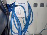 a blue hose attached to the side of a refrigerator