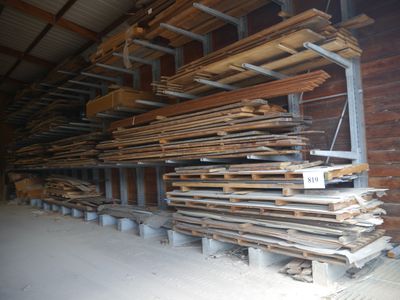 several stacks of wood are stacked up in a warehouse
