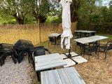 many tables and chairs that are outside in the grass