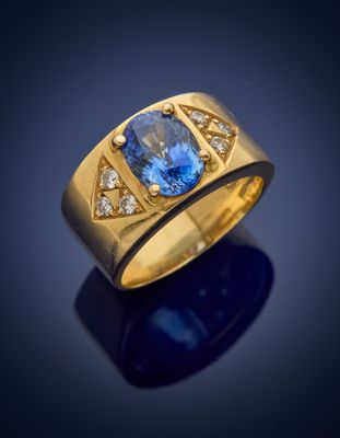 a yellow gold ring with a blue sapphire and diamonds