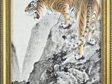 an image of a tiger on a mountain with a tree in the background