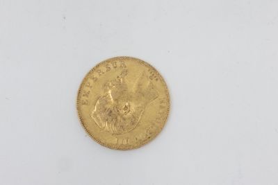 a gold coin on a white surface with a white background