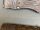 a knife that is laying on a table next to a knife