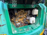 a green truck with a bunch of tools in the back