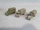three toy trucks sitting next to each other on a table
