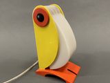 a yellow and white bird shaped lamp on a stand