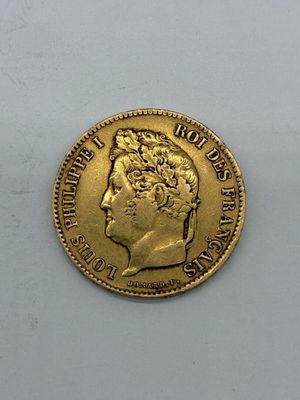 a close up of a gold coin on a white surface