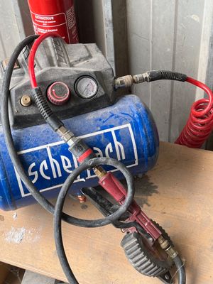 un compresseur d'air bleu posé sur une table en bois