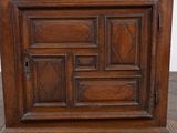 an old wooden cabinet with a door on the top of it