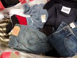 a pile of clothes that is sitting in a suitcase