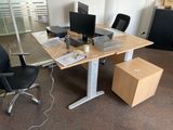 a desk with two computer monitors and a box on it