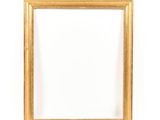 a gold frame on a white wall with a white background