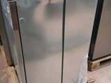 a refrigerator that is sitting on a pallet in a room