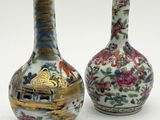 pair of chinese vases with floral designs on them on a white surface