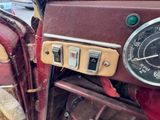 a close up of a red motorcycle with a clock on it