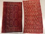 two pieces of red and black rugs on a white surface