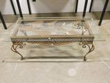 a coffee table with a glass top on a tile floor