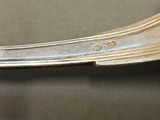 a close up of a silver spoon on a table