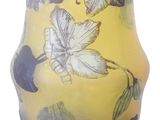a yellow vase with black and white designs on it