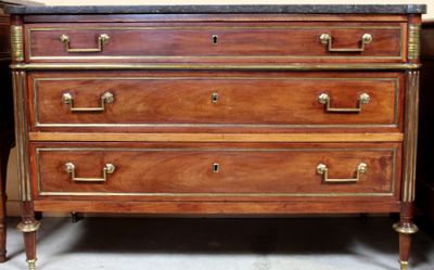 a wooden chest of drawers with marble top and brass handles