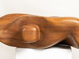 a wooden sculpture of a woman ' s torso on top of a pedestal