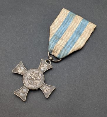 a close up of a medal with a cross on it