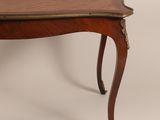 an antique table with a wooden top and brass trimmings on the legs