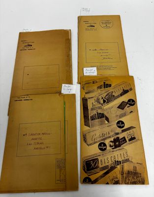 three old envelopes are sitting on top of a white table