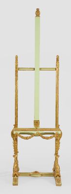 a gold stand with a green candle on it