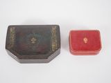 two small boxes sitting next to each other on a white surface