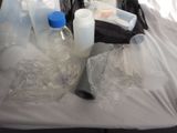 a plastic bag full of bottles and bottles on a table