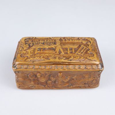 an old wooden box sitting on top of a white surface